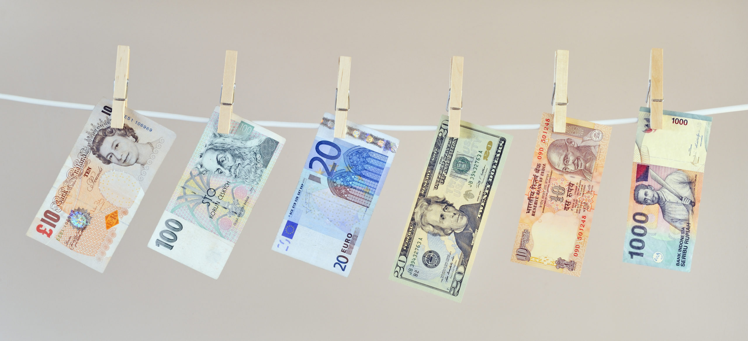 Money laundering concept, banknotes hanging on washing line